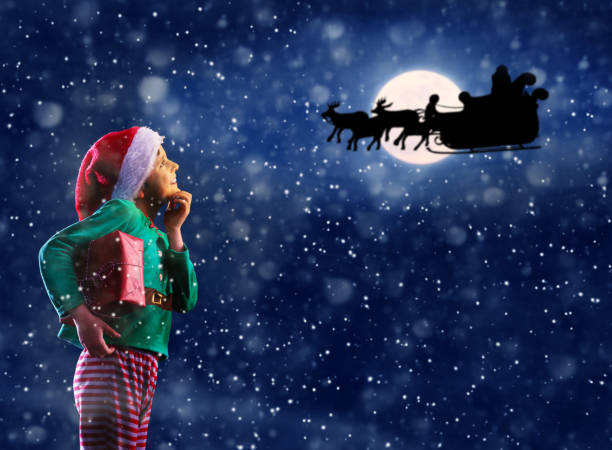 istock Thoughtful boy and Santa Claus sledge over moon 1251044534