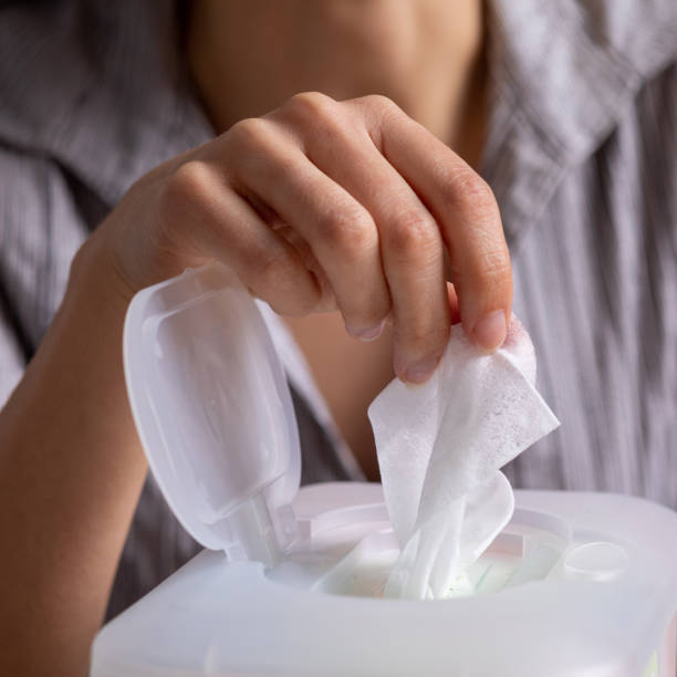 istock Wet wipes are universal an practical: woman take one wipe from big plastic box package for cleaning 1251045109