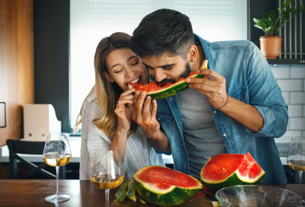 istock Young couple sharing a watermelon. 1251045722