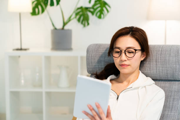 istock asian woman to see a tablet computer 1251048687