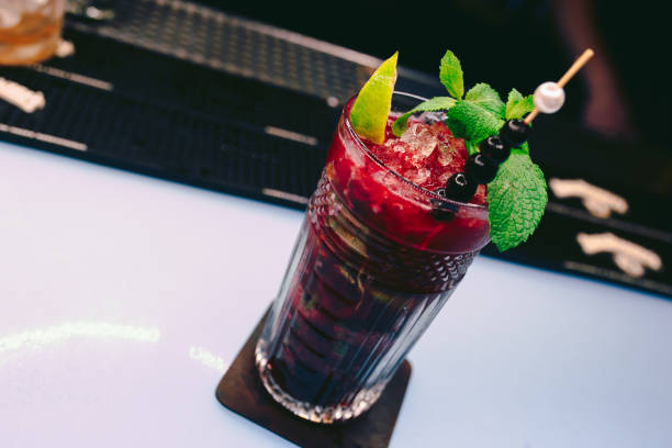 istock Fresh Berries Juice summer ice cold black currant Cocktail with Sweet decoration slice Author Drink - on bar counter . Close-up Top view . Copy paste space design barman people and luxury nightclub 1251049493