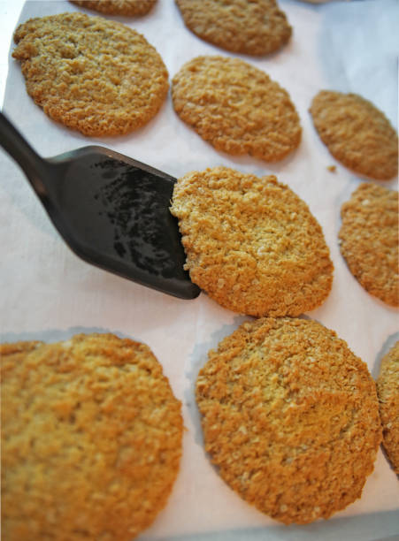 istock Someone takes a fresh baked cookie with a spatula. 1251050420
