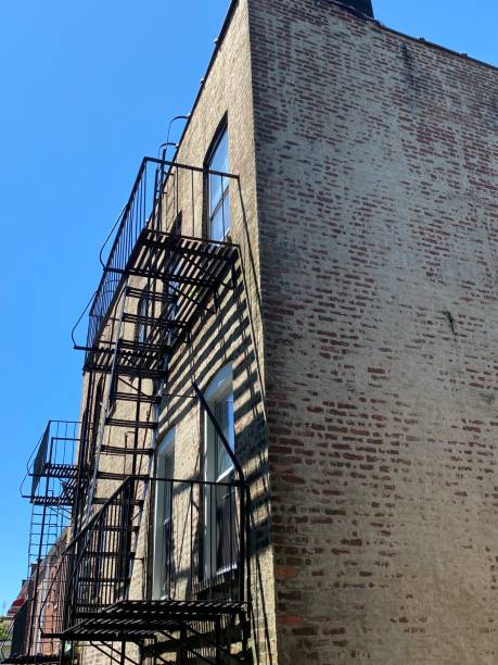 istock Rear view of building with black fire escape 1251052025
