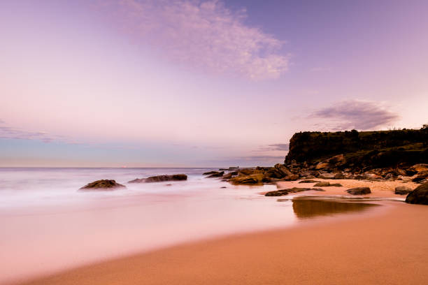 istock Walking along Burning Palms Beach under Twilight in Royal National Park 1251058325