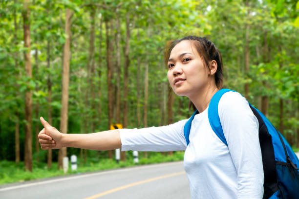 istock Woman hitchhiking 1251064137
