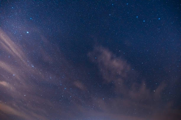 istock Real Night Sky Stars. Colorful Starry Sky With Some Clouds Background Backdrop 1251064957