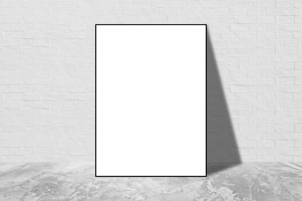 istock Black blank frame in white brick wall with concrete floor texture interior room background. 1251067622