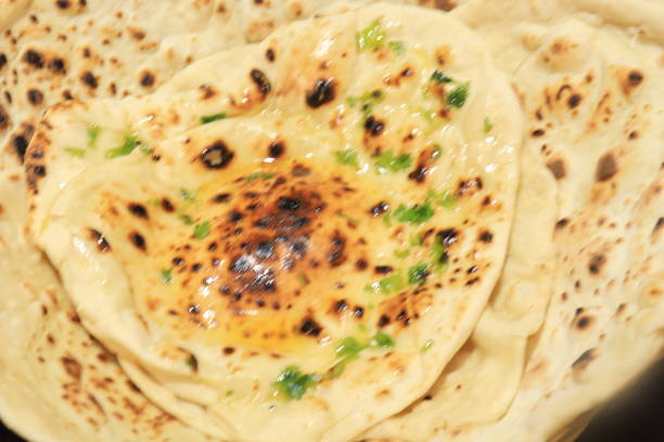istock Homemade Butter Naan isolated on black background 1251070082