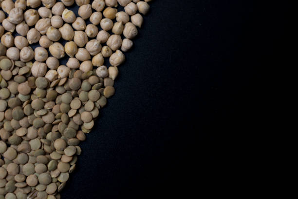 istock Chickpeas and lentils on a black board, black background. 1251074627