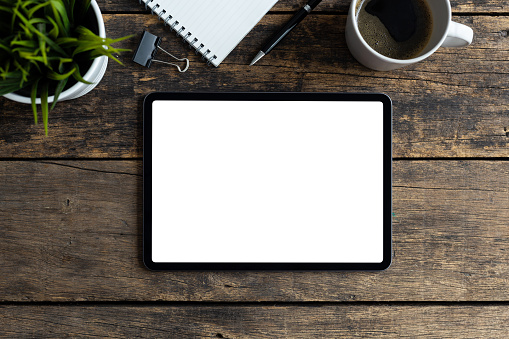 Mockup image tablet with blank white screen on wooden table