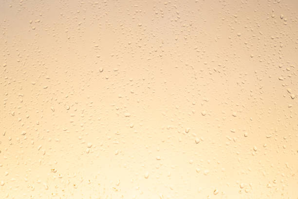istock light yellow glass background with raindrops, autumn sunset, texture, 1251076399