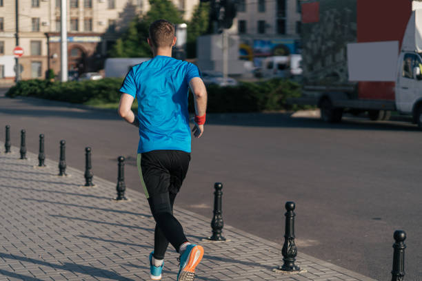 istock Attractive fit man running in the city 1251076703