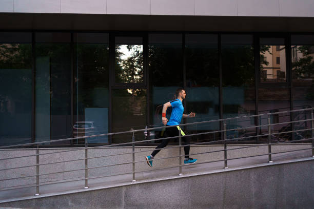 istock Attractive fit man running in the city 1251076738