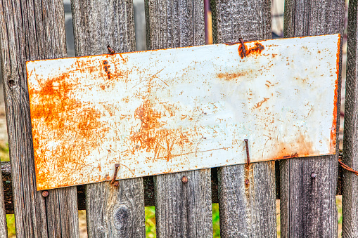old street name plate at the wooden fence