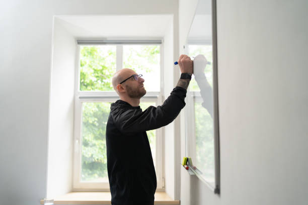 istock Young man writing on a whiteboard in an office, 1251083745