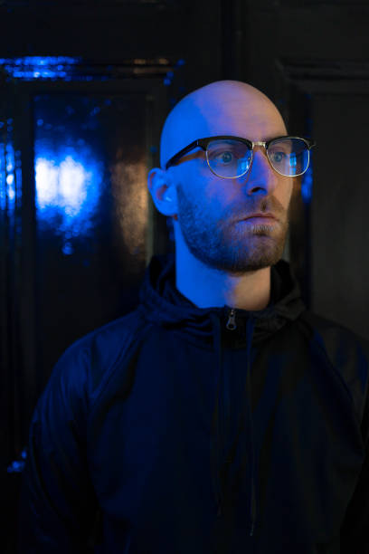 istock Neon light studio close-up portrait of serious man 1251083807