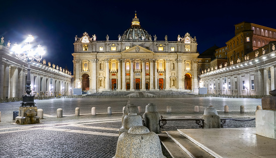 Vatican, Italy, June 18 -- A splendid night view of the square of St. Peter's Basilica without people. The Basilica is the center of the Catholic religion, one of the most visited places in Rome for its immense artistic and architectural treasures. Photo in High Definition Format.