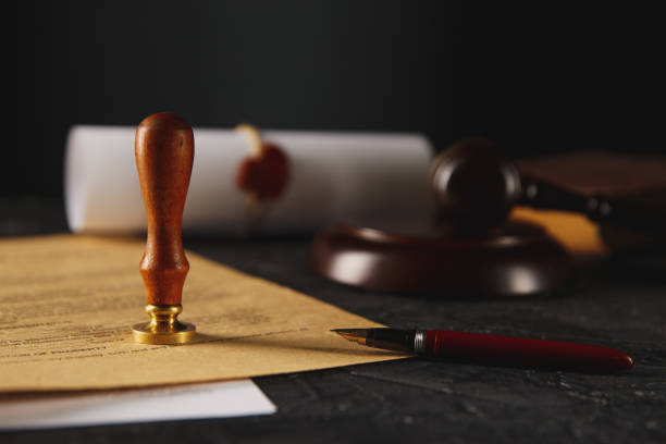 istock Notary's public pen and stamp on testament and last will. Notary public tools 1251086669