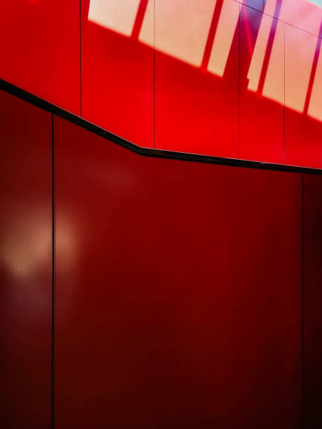 istock Red wall with black stripes with sunny stripes 1251090263