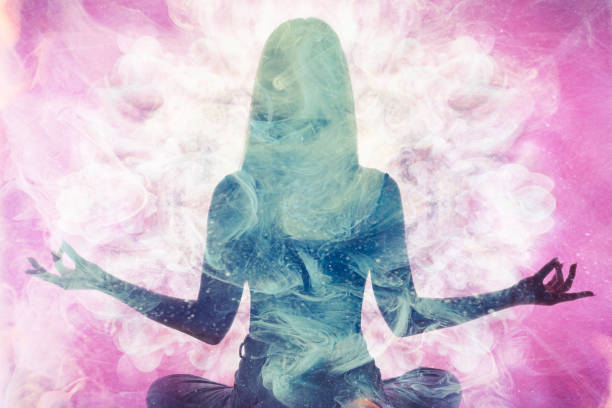 spiritual practice meditating woman silhouette Spiritual practice. Harmony balance. Meditating woman silhouette in pink ethereal smoke double exposition. aura stock pictures, royalty-free photos & images