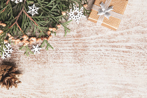 Christmas frame with fir tree branches on wooden background