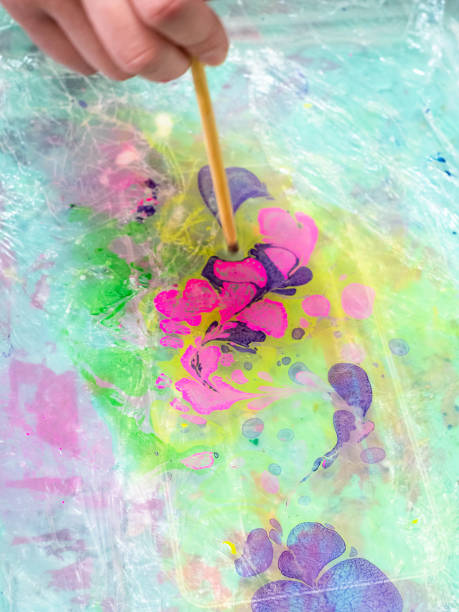 istock mixing of dyes on surface of liquid in basin 1251095229