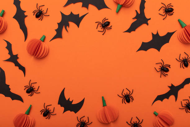 Halloween orange background. Modern design. Holiday party decoration. Flat lay.