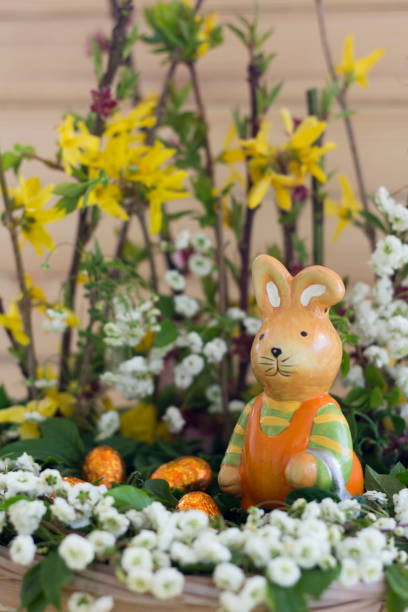 istock Easter Arrangement With Spring Flowers, Ceramic Rabbit And Chocolate Eggs In Basket 1251095441