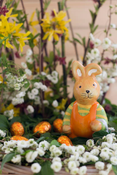 istock Easter Arrangement With Spring Flowers, Ceramic Rabbit And Chocolate Eggs In Basket 1251095453