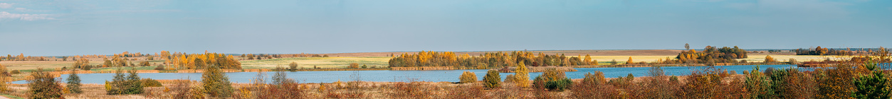 Autumn Nature. Panorama Of Landscape With River Lake Or Pond In Sunny Day With Blue Clear Sky. Belarus, Europe.