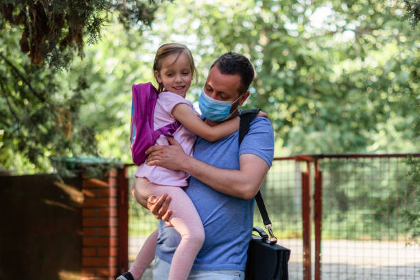 istock Child and working father wearing face mask going to kindergarten 1251098013