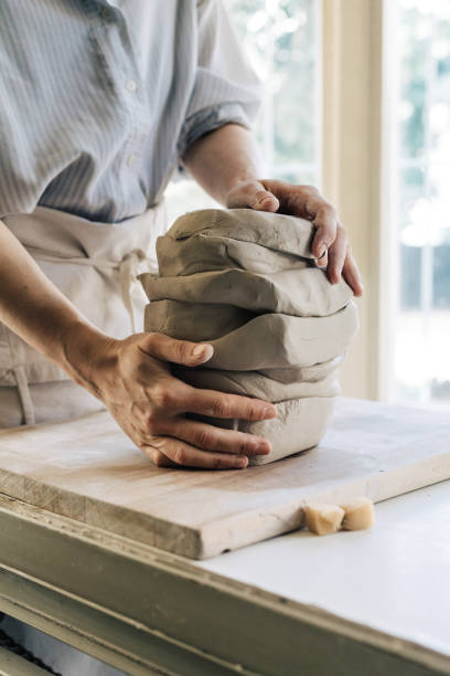 istock Woman Potter  Cutting and Molding Clay at her Studio 1251099661
