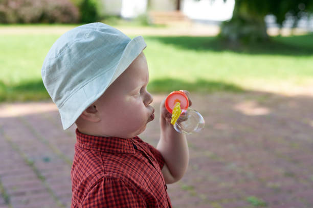 istock A little boy diligently blows soap bubbles. 1251101504