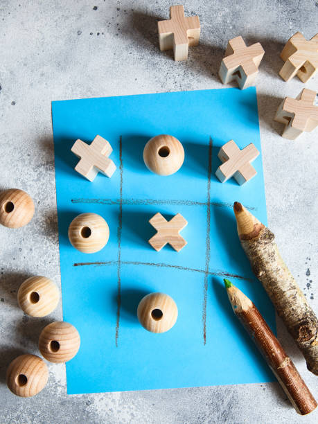istock Tic tac toe game with wooden figures on a blue background 1251102970