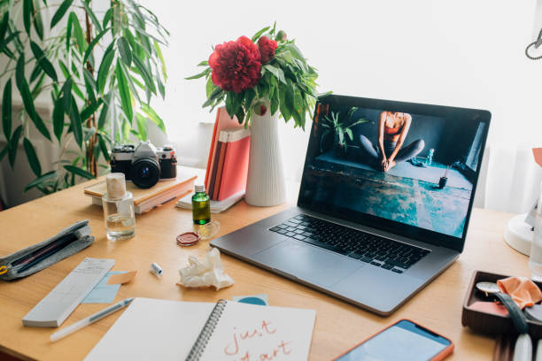 istock Open Laptop on a Woman's Messy Desk at Home 1251103186
