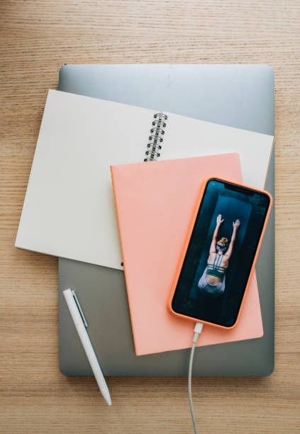 istock Motivational Mondays: a Mobile Phone, a Notebook and a Laptop on a Woman's Desk 1251103195