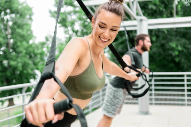 istock Couple endurance workout with TRX straps outdoors 1251105147