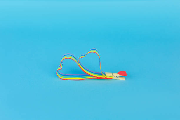 istock Rainbow ribbon awareness for LGBT community on blue background 1251107223