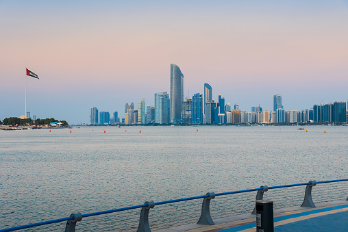 Abu Dhabi downtown skyline cityscape waterfront view in the United Arab Emirates at sunset