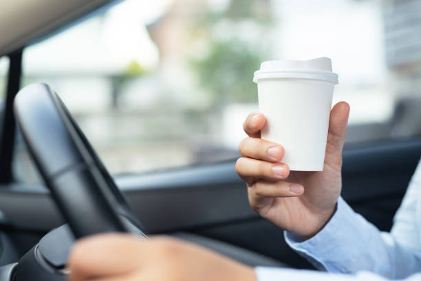 istock Man is drinking hot coffee in the car before going to work at the office every time. 1251115002
