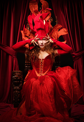Queen of Fire type character on the throne in a studio shot