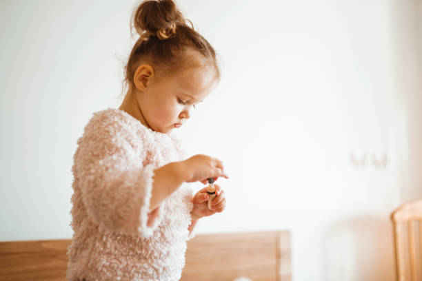 istock Little girl doing makeup to mom. 1251124639