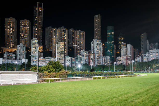 Empty race track and skyline background, Horse racing course in Hong Kong Jockey Club, Happy Valley Empty race track and skyline background, Horse racing course in Hong Kong Jockey Club, Happy Valley derby city stock pictures, royalty-free photos & images