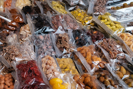 snacks, dried fruits and sweets on food, market