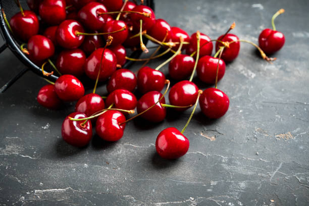 istock Ripe and juicy cherries on the dark rustic background 1251134161