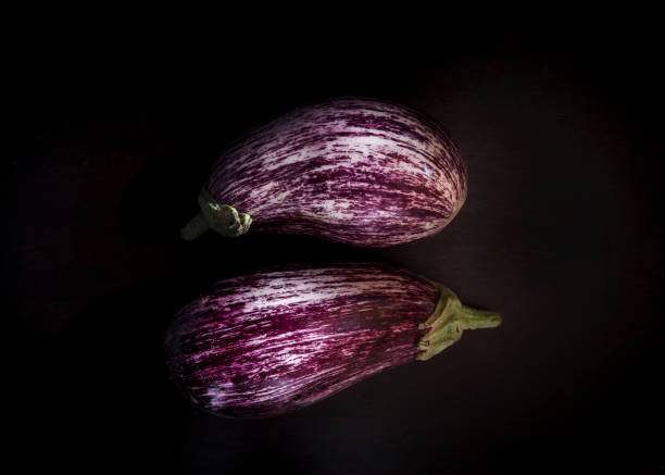 istock Close-up of eggplants on a black background 1251135037