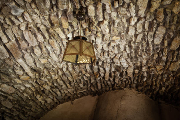Old fashioned vintage lantern lamp hanging on the ceiling in cellar