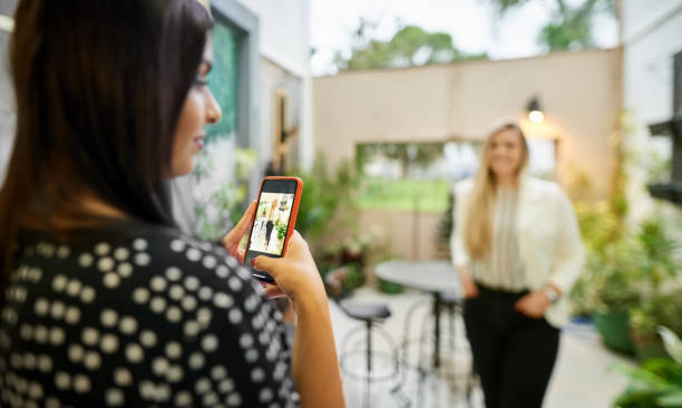 istock Woman photographing friend 1251136314