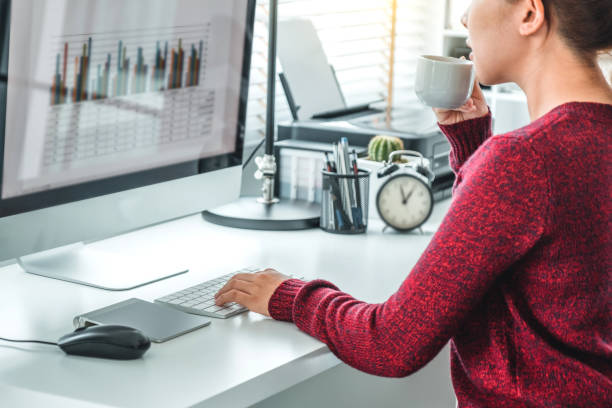 istock Asian woman working from home using computer and drinking coffee in her bedroom document finance and conference online meeting for new projects 1251136370