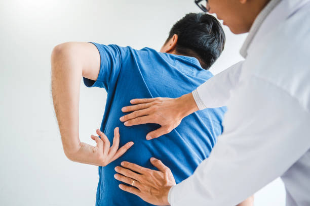 istock Physical Doctor consulting with patient about Back problems Physical therapy concept 1251136405